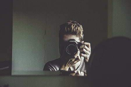 man taking photo of mirror thumbnail