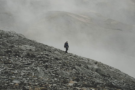 man walks on mountain on focus photo thumbnail