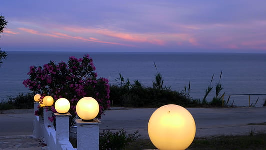 brown lamps near seashore during sunset thumbnail