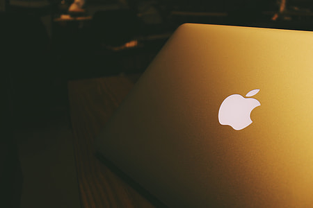 slightly opened MacBook placed on table thumbnail
