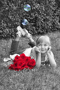 selective photography of red flowers near smiling girl thumbnail