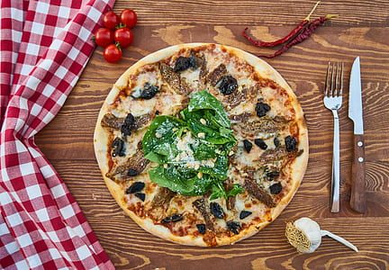 pizza beside gray dining fork and knife thumbnail