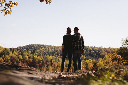 two persons standing facing trees thumbnail
