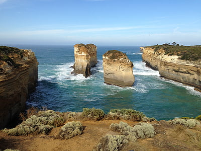two brown rock formation surrounded by water at daytime thumbnail