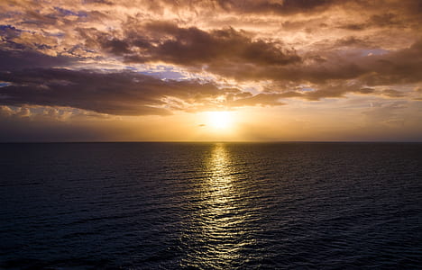 photography of body of water during golden hour thumbnail