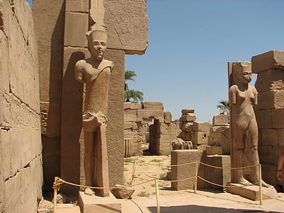 brown concrete sculptures beside wall thumbnail