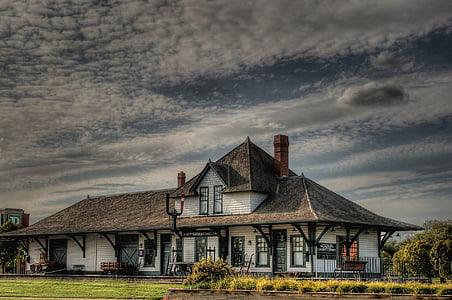 photographed of white and brown wooden house during blue sky thumbnail