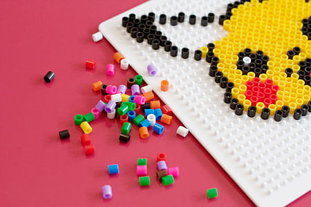 Pokemon Pikachu hama beads on red surface thumbnail