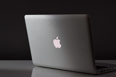 opened MacBook White on white table top thumbnail