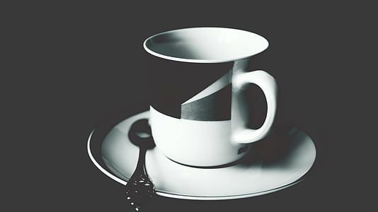 empty black and white ceramic teacup on white plate thumbnail