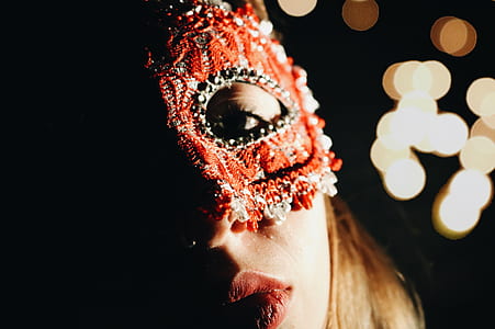 woman wearing red Columbina mask thumbnail