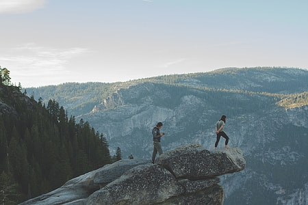 man and woman on grey stone mountain during daytime thumbnail