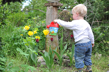 boy holding red plastic watering can thumbnail