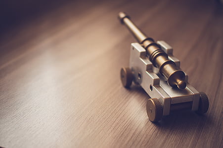 gray and brown cannon miniature on brown surface thumbnail