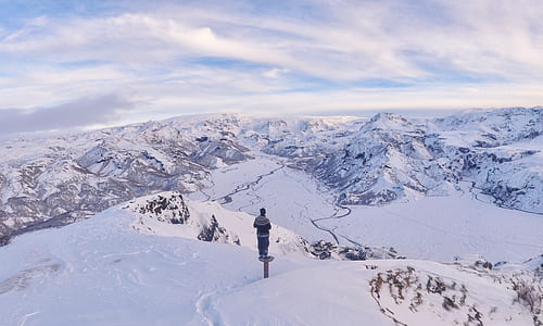 man on top of mountain with snows thumbnail