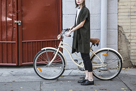 woman holding white beach cruiser bike thumbnail