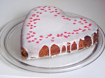 heart-shaped milk coated cake on top of clear glass plate thumbnail