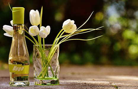 Clear Glass Hugo Bottle With White Flowers thumbnail