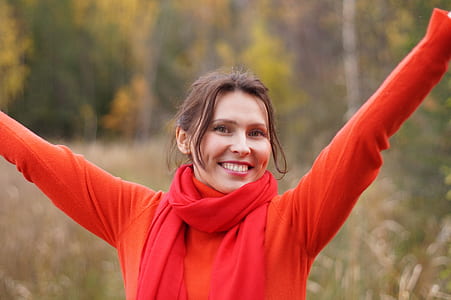 photo of woman wearing orange sweater and red scarf thumbnail