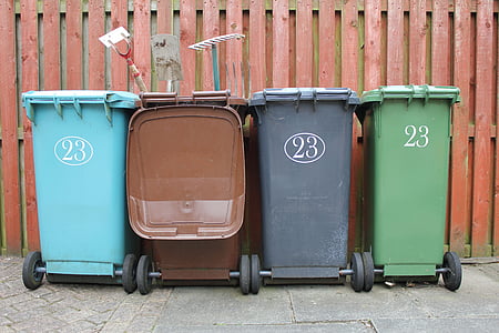 four brown, teal, black, and green wheelie beanie garbage bins taken at daytime thumbnail