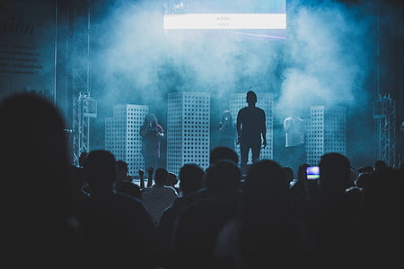 silhouette photography of singer on stage thumbnail
