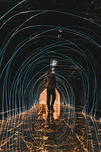 man wearing gray full-zip jacket and black pants standing on tunnel thumbnail