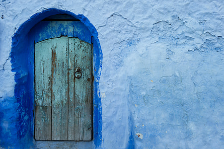 photo of brown wooden door and blue wall at daytime thumbnail