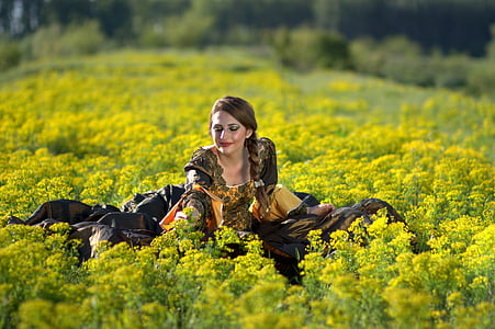 shallow focus photography of woman in yellow rapeseed flower field thumbnail