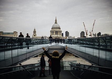 man standing in the middle of walkway facing white dome building thumbnail