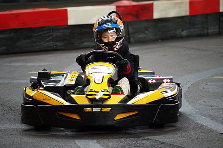 boy driving go-kart on race track thumbnail