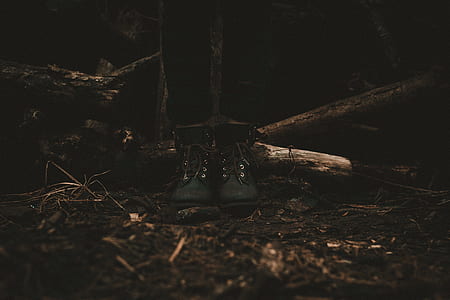 person wearing pair of black shoes standing on brown soil thumbnail