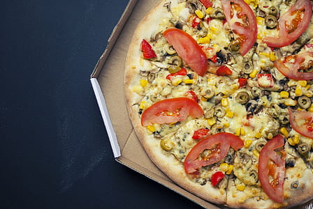 pizza pie with tomatoes and mushroom on brown cardboard box thumbnail