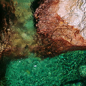 aerial photo of beige rock formation near lake thumbnail
