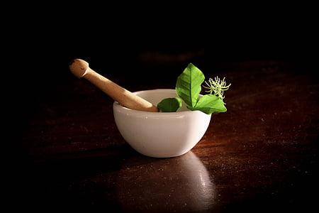 mortar and pistle on wooden surface thumbnail