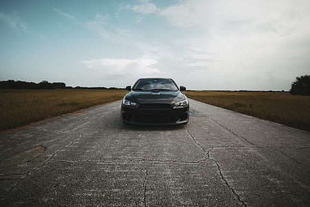 black car on pathway thumbnail
