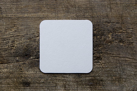 square white card on brown wood board panel thumbnail