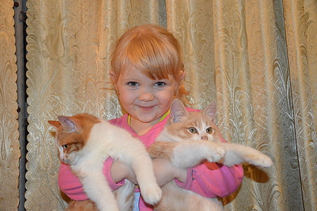 girl holding two orange cats thumbnail