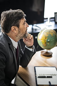 man sitting beside table thumbnail