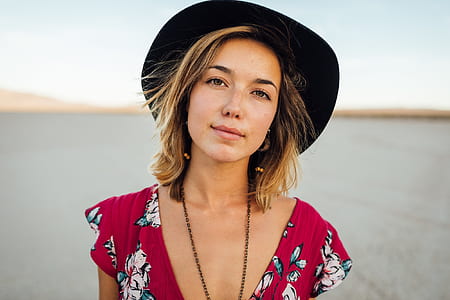 woman wearing black cowboy hat and red floral tops photography thumbnail