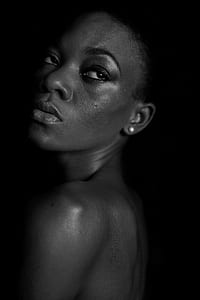 grayscale photography of facing on left wearing pearl stud earrings thumbnail