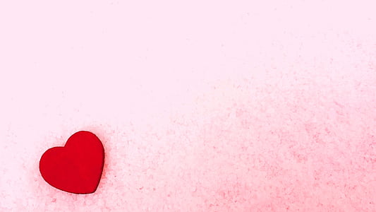 red heart wooden decor on pink sheet thumbnail