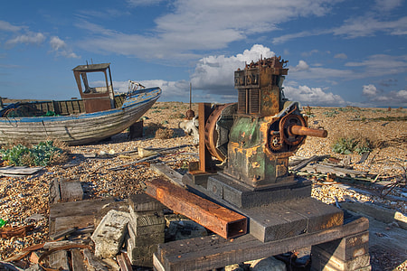 An abandoned boat and engine lie on the coast at Dungeness, Kent, England thumbnail