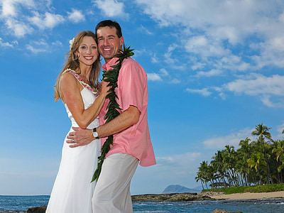 hugging couple at beach during cloudy daytime thumbnail