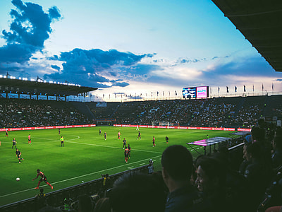 people watching soccer game under white clouds and blue sky at daytime thumbnail