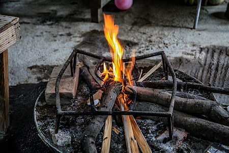 burning wood on firepit with grill thumbnail