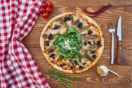 pizza on brown wooden surface thumbnail
