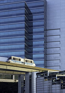 gray and blue train near buildings timelapse photography thumbnail