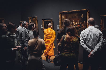 people standing near wall with paintings thumbnail