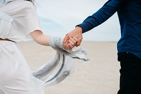 photo of man and woman holding hands thumbnail