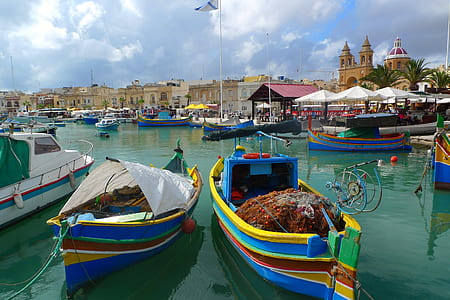 two green-and-blue paddle boats on body of waters thumbnail